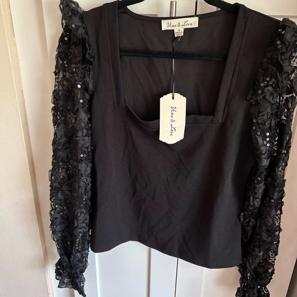 Beautiful light weight sweater with sequin arms